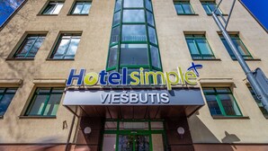 A hotel named 'Hotelsimple' with a modern facade, multiple windows, and a prominent entrance. - Hotel Simple Plus (Vilnius)