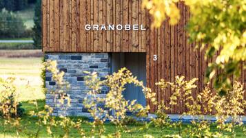 A wooden building with the name 'GRANOBEL' and the number '3' on its facade.