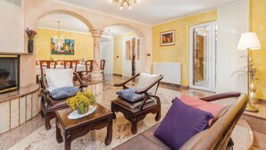 A spacious living area with a fireplace, comfortable seating, and a dining area. - Amazing home in Labin (Labin)
