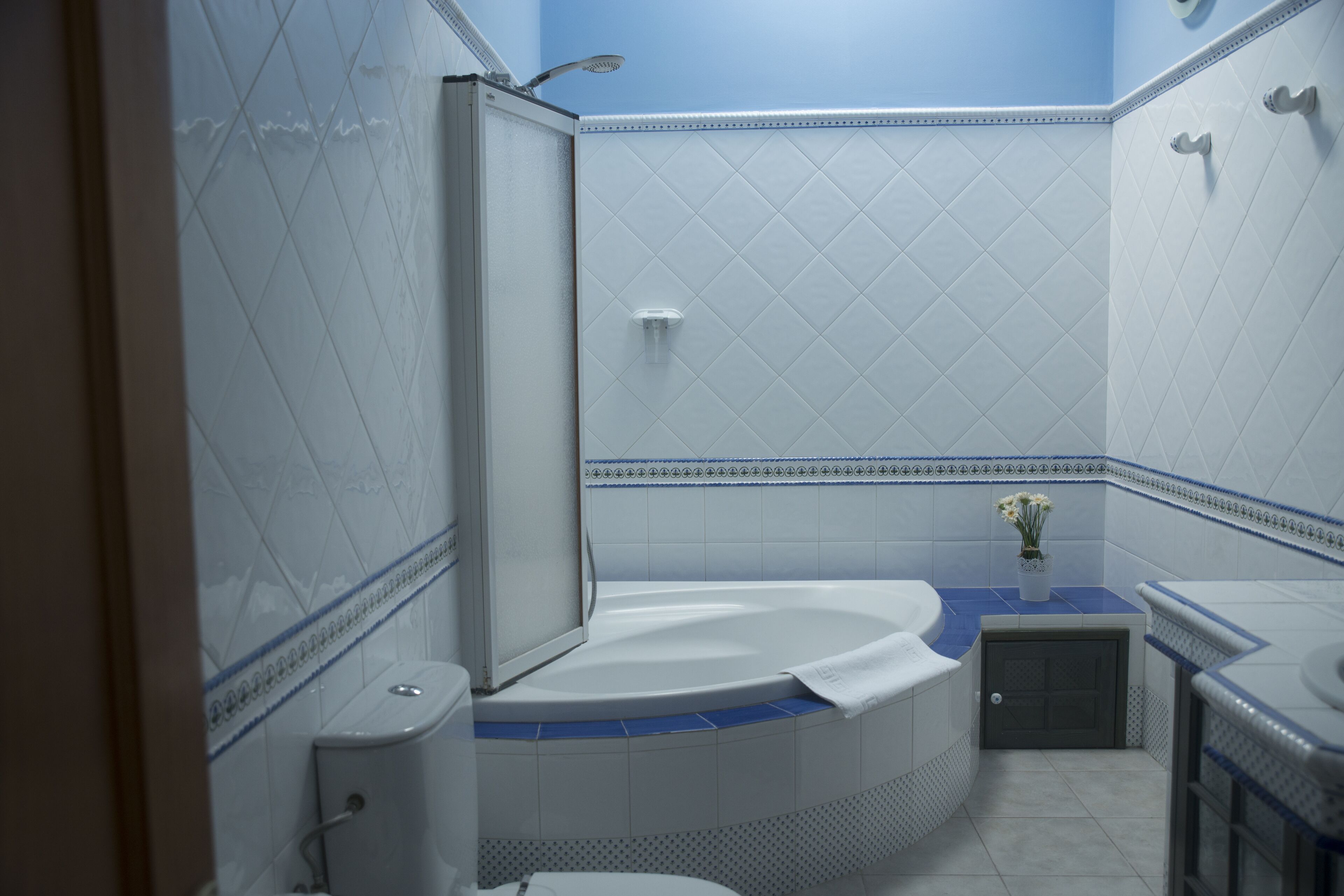 A bathroom with a bathtub, toilet, and shower.