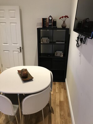 Enjoy meals and meetings in this well-organized room with a dining table and comfortable seating for two.