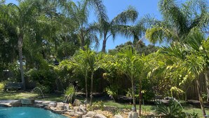 A swimming pool surrounded by rocks and tropical plants. - "Private Pool Oasis • 3-Min
Walk to Crystal Beach •
Tropical Escape" (Crystal Beach)