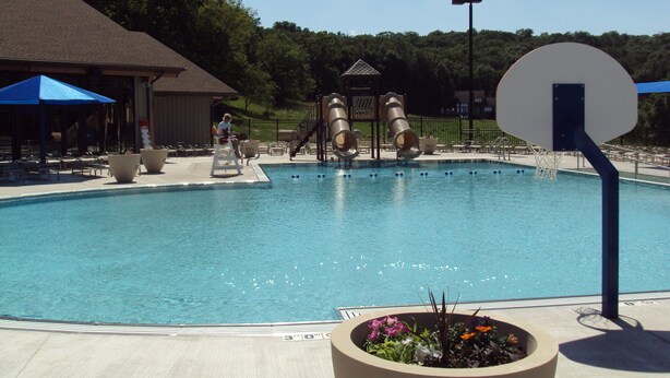 A swimming pool with a basketball hoop, slides, and lounge chairs. - 2 Bedroom, 2 bath home in The Galena Territory.  Close to Eagle Ridge Resort (Galena)