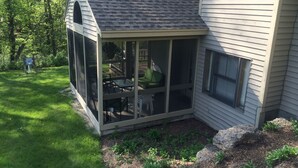 A house with a covered patio area featuring a table and chairs. - 2 Bedroom, 2 bath home in The Galena Territory.  Close to Eagle Ridge Resort (Galena)