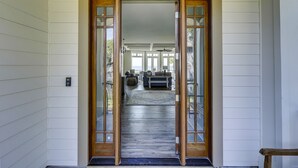 A hallway leading to a living area with a view of the outdoors. - Perfect 10 Sea Hawk-Spectacular Oceanfront Dream House in Absolute Best Location (Hilton Head Island)