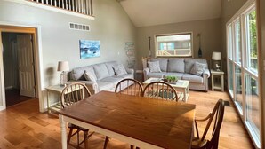 A spacious living area with a wooden dining table, grey sofas, and a ceiling fan. - Lakefront home near Mammoth Cave (Mammoth Cave)