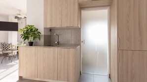 Een moderne keuken met houten kastjes, een granieten aanrechtblad en een ingebouwde kookplaat.