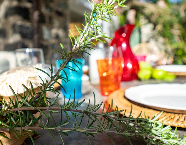 A table with a wooden tray, a sprig of rosemary, and a blue glass. - Villa La Pavona Luxury Collection (Monterosso al Mare)