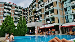 A swimming pool area with a building labeled "ÄKTINIA" in the background. - Aktinia (Nessebar)