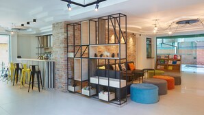 A modern interior with a bar area, seating, and a brick accent wall. - Aktinia (Nessebar)