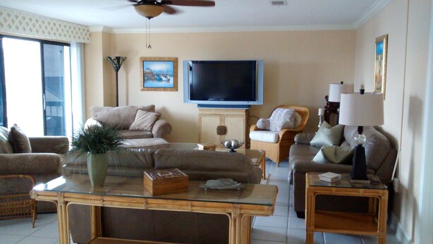 A living room with a sofa, armchairs, a coffee table, and a TV. - Beauvoir (Beautiful View) (Biloxi)