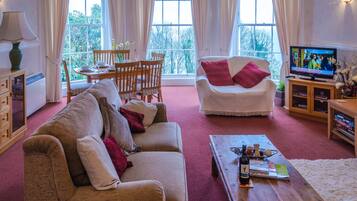 Deluxe Apartment, 2 Bedrooms | Living room | TV