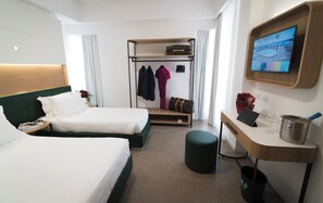 A hotel room with two beds, a desk, a TV, and a coat rack. - M&F Hotel (Gallipoli)