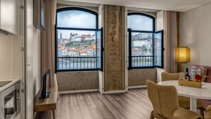 A hotel room with a large window offering a view of a cityscape. - 296 Heritage Apartments (Vila Nova de Gaia)