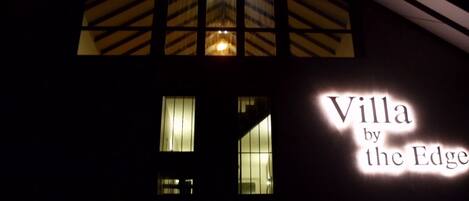 A building with a sign reading "Villa by the Edge".