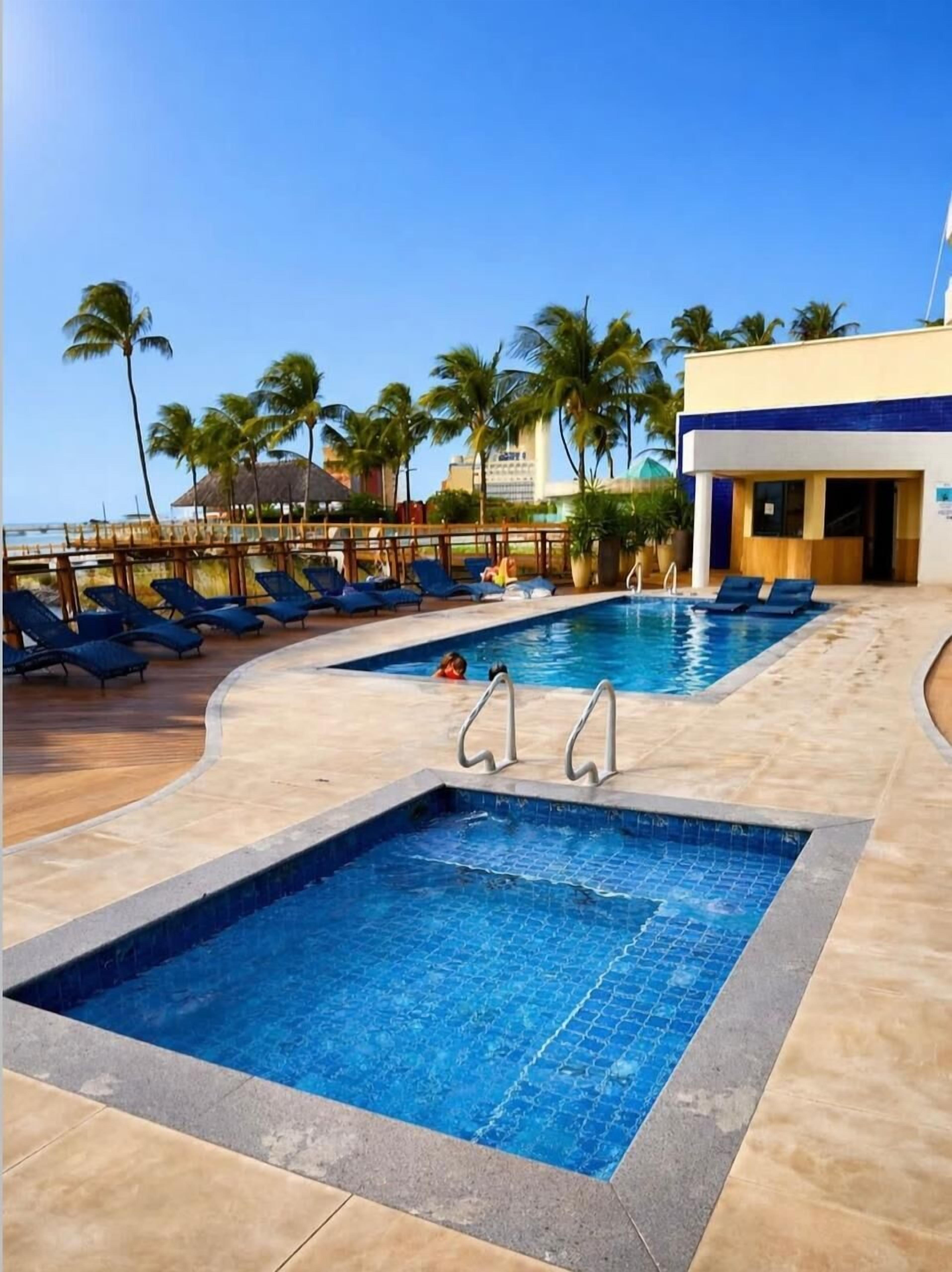 Outdoor pool, open 7:00 AM to 10:00 PM, pool loungers