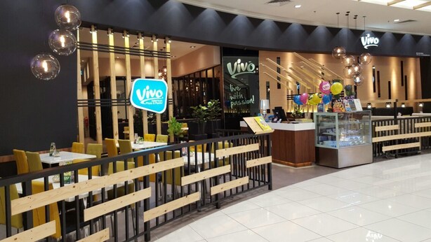 A Vivo restaurant with a modern interior, wooden seating, and a glass display case. - Family Suite DESA TEBRAU JOHOR BAHRU (Johor Bahru)