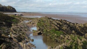 A rocky coastal landscape with a narrow water channel. - Powillimount Cottage (Dumfries)