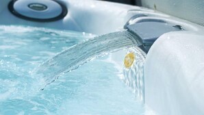 A close-up of a hot tub with clear water flowing into it. - Oak Cottage (Hot Tub) (Brampton)