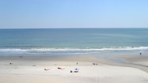 A wide sandy beach with a clear view of the ocean. - A Place at the Beach - Windy Hill (North Myrtle Beach)