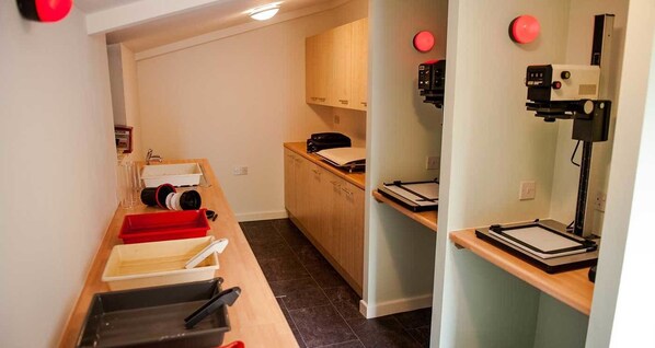 A kitchen with a countertop, a sink, and a microwave.