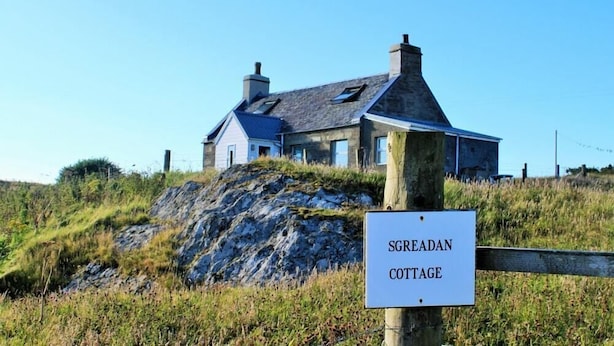 A cottage named Sgreadan Cottage, surrounded by natural landscape.