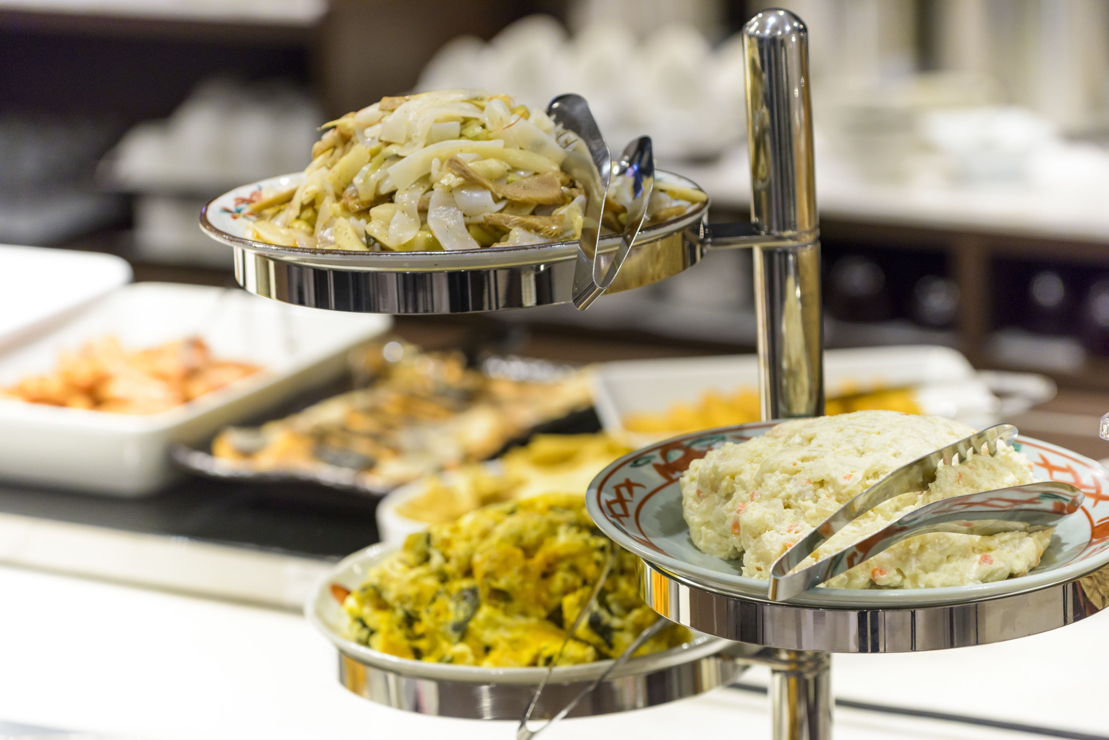 A buffet with various dishes served in metal containers.