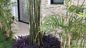 A modern building with a stone facade and large windows. - Yaax Kiin (Tulum)