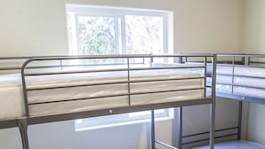 A bunk bed room with metal railings and a window. - Los Angeles Extended Stay Hostel (Los Angeles)