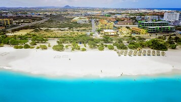 Una playa cerca, arena blanca, sillas reclinables de playa