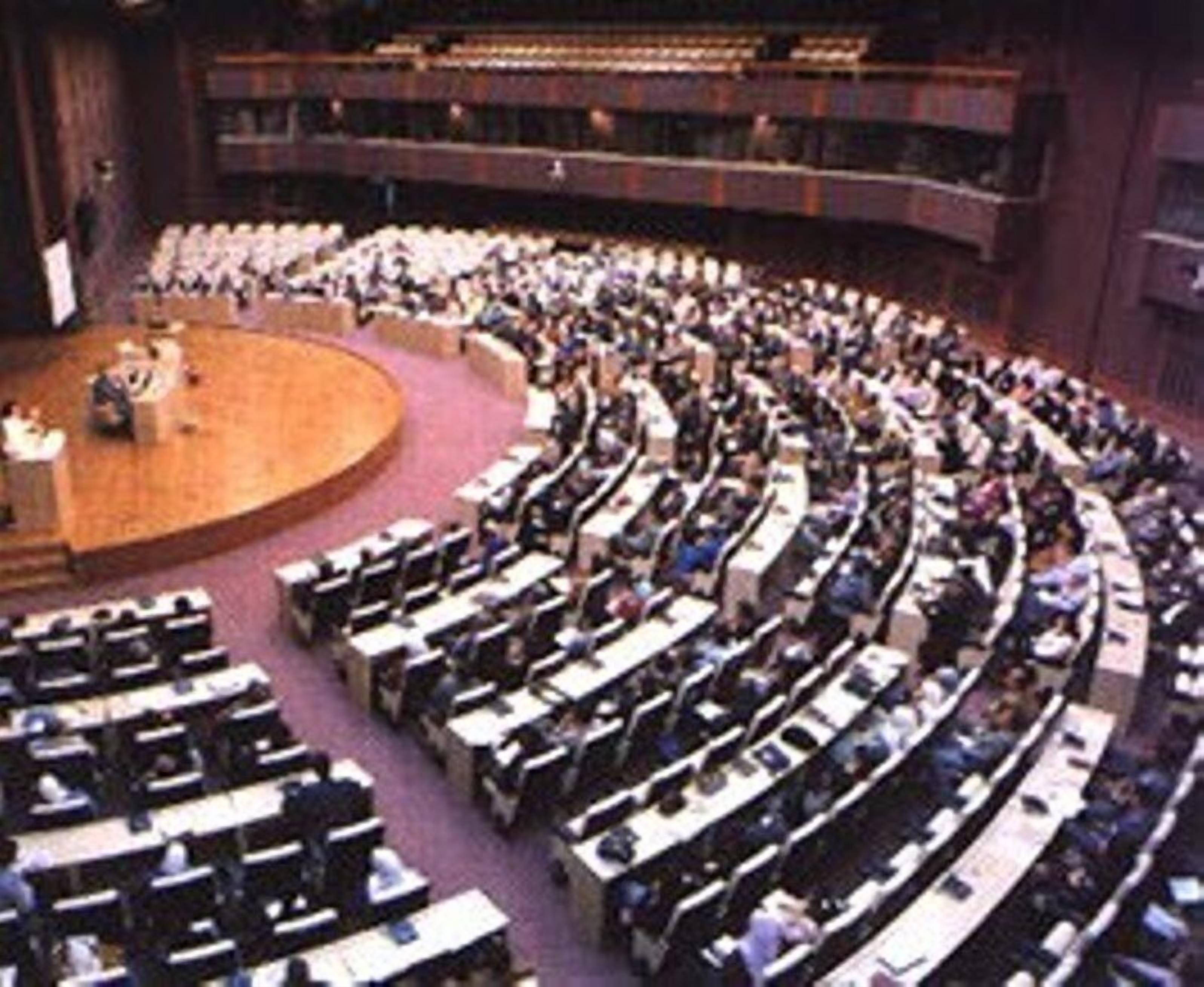 A large auditorium with tiered seating and a stage at the front.