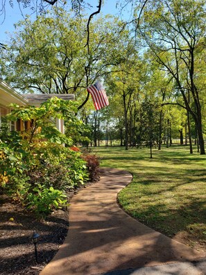 Surrounded by lush greenery and mature trees, this serene home offers a peaceful retreat.