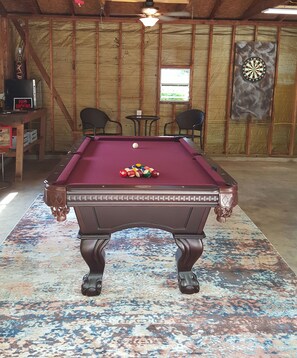 Enjoy a game of pool or darts in this cozy room with a billiards table and dartboard.