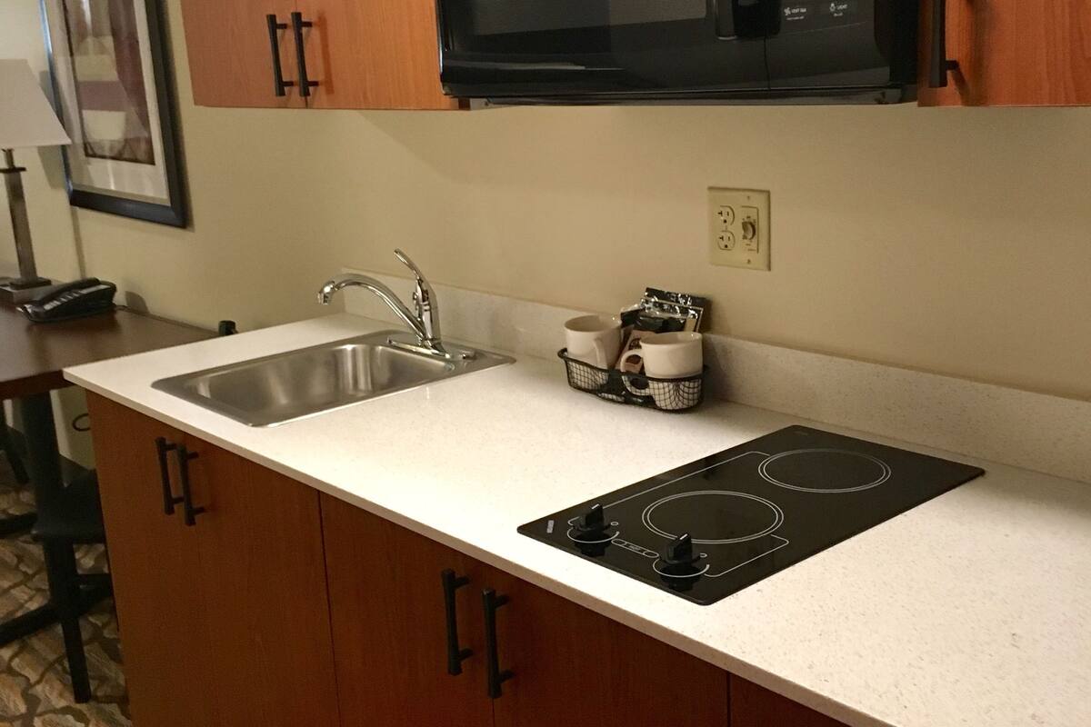 full-sized fridge, microwave, stovetop, coffee/tea maker