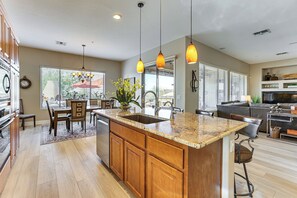 Enjoy cooking in this well-equipped kitchen with ample workspace and storage, a dining area, and a cozy seating area.