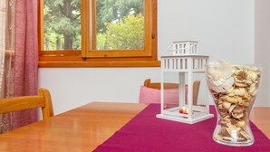 A wooden table with a pink table runner, a white lantern, and a vase with dried flowers. - Authentic Stone Villa In The Heart Of Split, Next To Diocletian's Palace  (Split)
