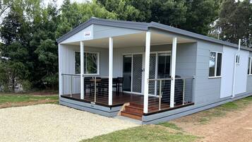 Guests can enjoy a covered porch with a deck and windows.