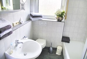 Een bad, een haardroger, handdoeken, zeep