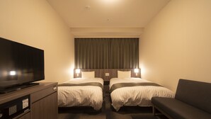 A hotel room with two beds, a TV, and a sofa. - Dormy Inn Korakuen Hot Springs (Tokyo)