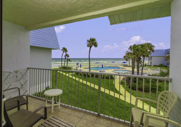 Enjoy breathtaking views of the beach and pool from this balcony.