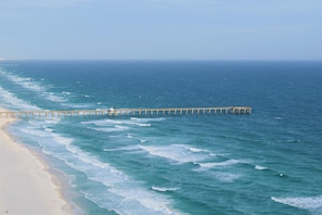 A beach with a long pier extending into the ocean. - Tidewater! Newly remodeled beach front luxury condo with beach servic (Panama City Beach)