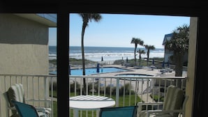 A balcony with a view of a pool and the ocean. - Sandpiper 228 - Paradise Found at Crescent Sandpiper 228 (St. Augustine)
