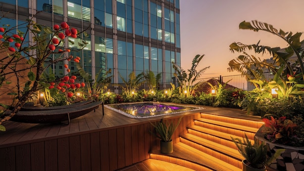 A rooftop garden with a hot tub, wooden deck, and various plants. - Grand Cititel Hanoi Hotel & Spa (Hanoi)