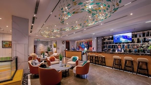 A modern hotel lobby with a bar area, seating arrangements, and a decorative ceiling. - Grand Cititel Hanoi Hotel & Spa (Hanoi)
