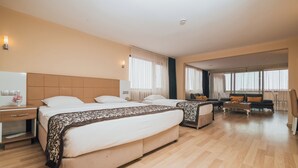 A hotel room with a large bed, a desk, a chair, and a sofa. - Konak Park Hotel (Akçaabat)
