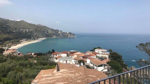 A coastal town with terracotta-roofed buildings, a beach, and a clear view of the sea. - Baia dell'est (Montauro)