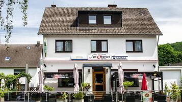 Experience the charm of a traditional European building, home to a cozy cafe and restaurant with a welcoming entrance and scenic views.