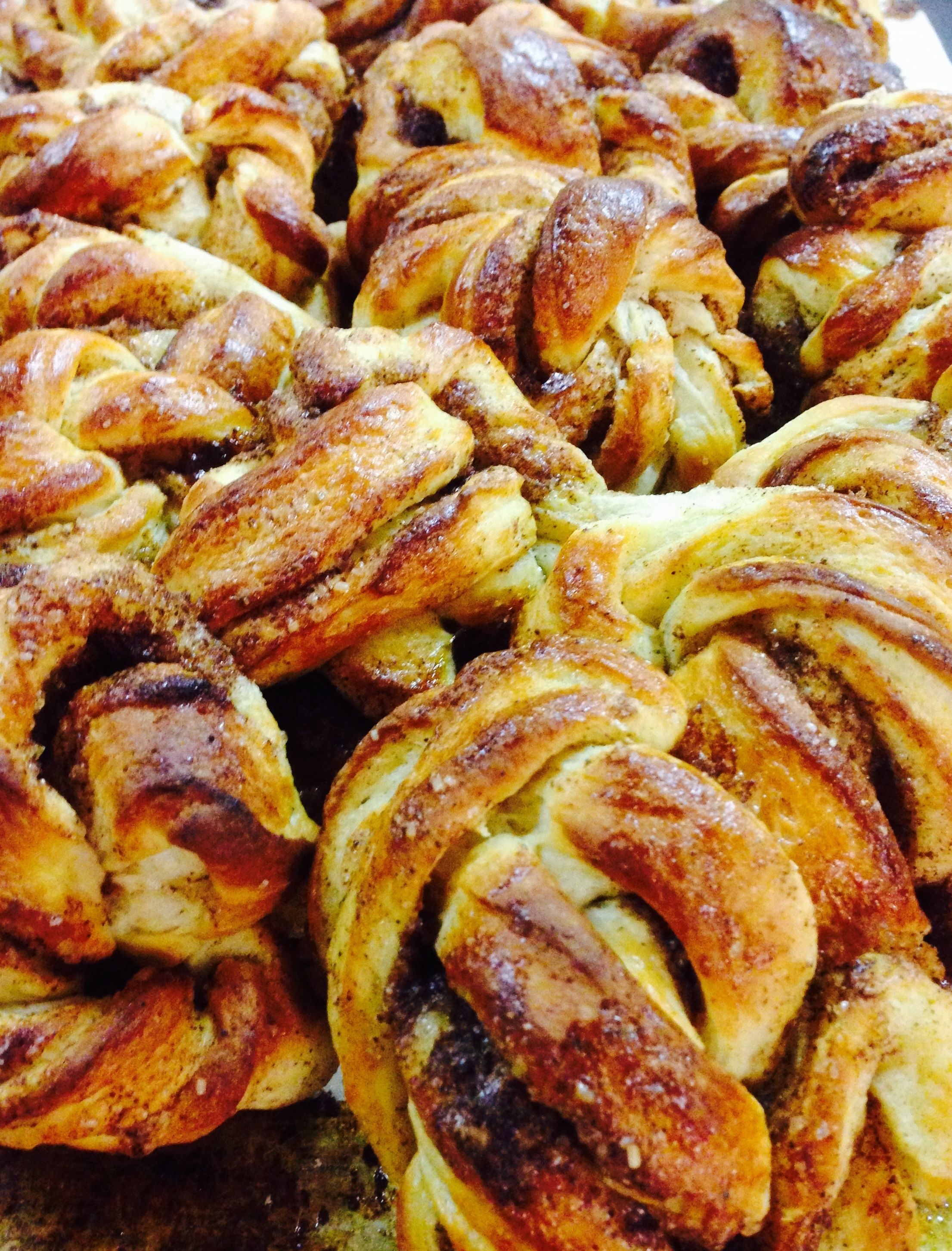 A close-up of braided pastries with a golden-brown crust.