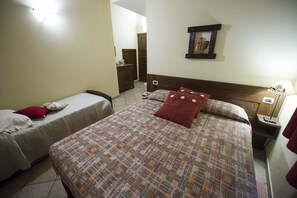 Relax in a cozy space with a large bed, nightstand, and dresser, perfect for a comfortable stay.