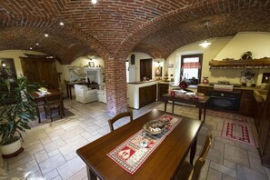 Relax in this open-plan living area with a high ceiling, dining table for four, and a kitchen with ample counter space.